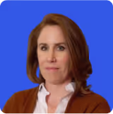 Woman with shoulder-length brown hair wearing a white blouse and brown cardigan against a blue background.